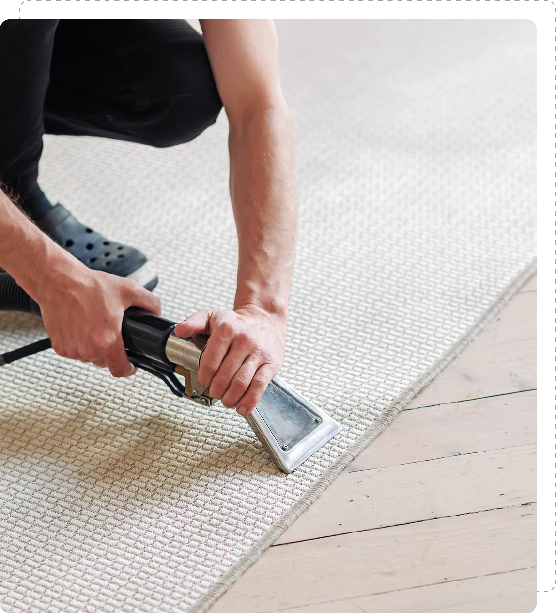 Person cleaning carpet with a vacuum tool. Person cleaning carpet with a vacuum tool.