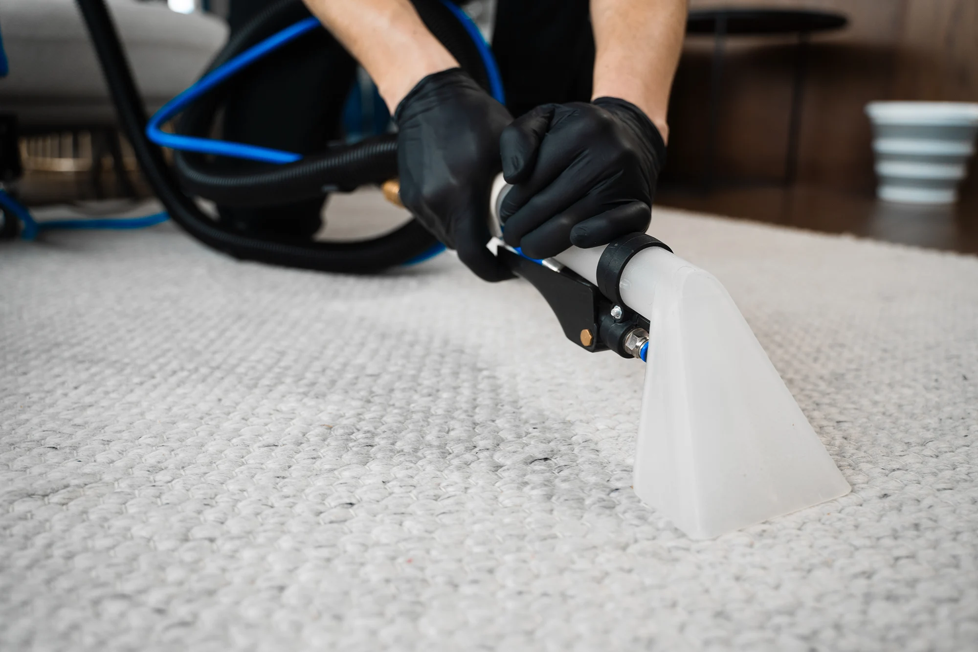 Cleaning carpet with a vacuum tool.