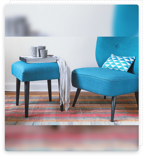 Task 4 Blue armchair with a matching ottoman and a cozy throw in a stylish living room.